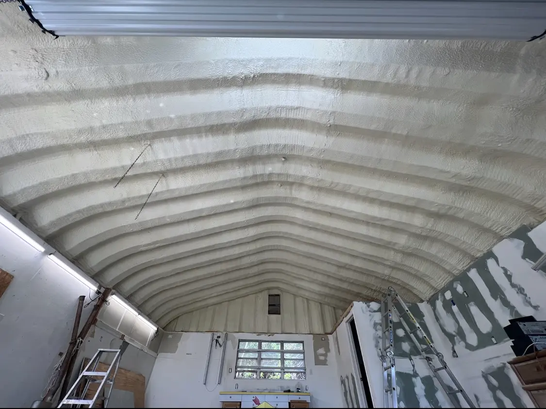 Spray polyurethane foam applied to the underside of a metal roof deck in Winder